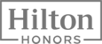 The image is a logo for "Hilton Honors," featuring the words in a bold, classic font within a rectangular border.