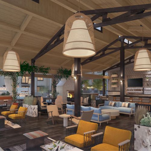 The image shows a spacious, modern lounge with wooden ceiling, cozy seating, large lamps, plants, and a bar area with multiple TVs.