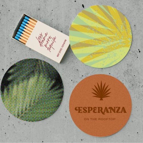 The image shows a matchbox with matches and three coasters: one with a sunburst pattern, one dotted, and one that says “Esperanza on the Rooftop.”